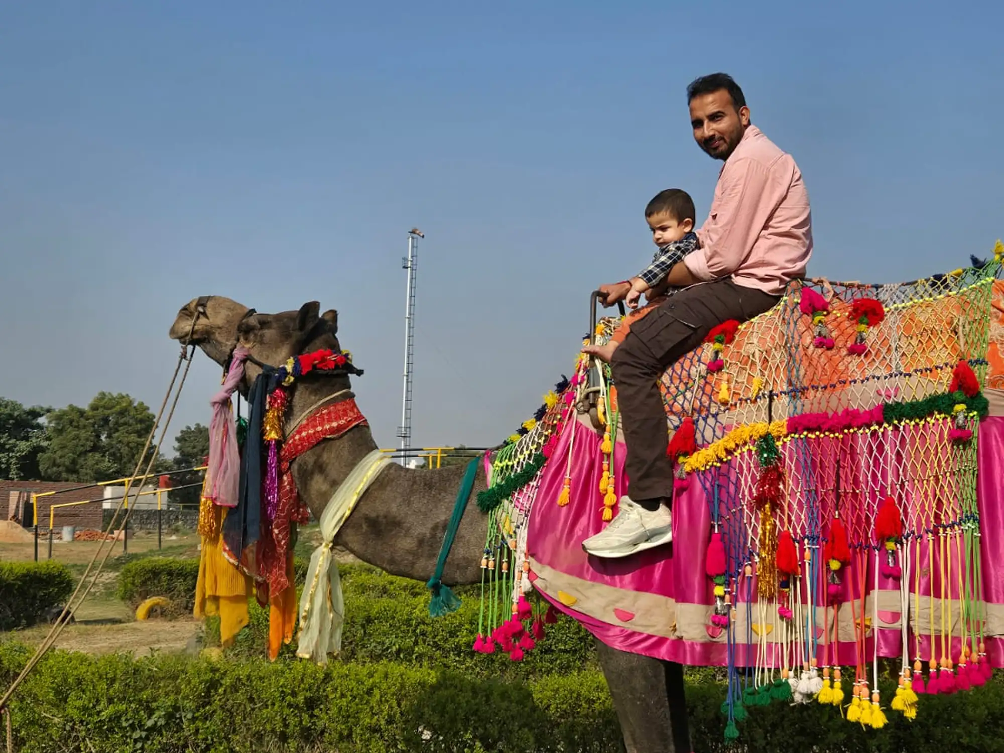 Father and child enjoying a camel ride at Veda Adventures