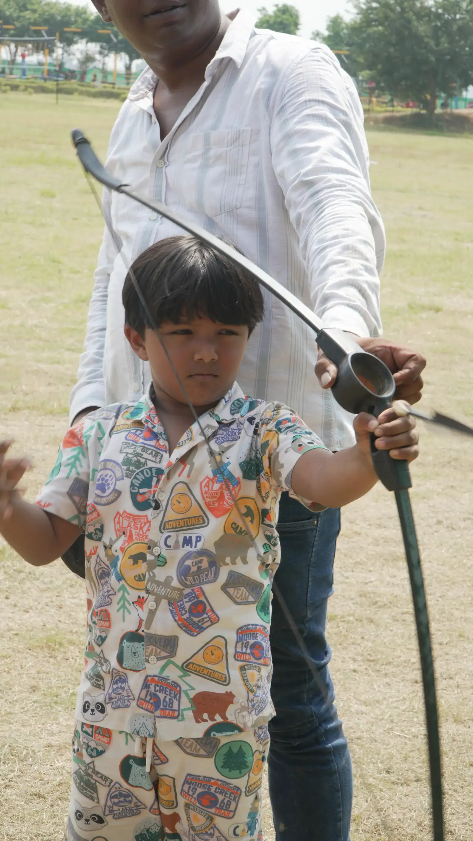 Indian student aiming at an archery target at Veda Adventures Park