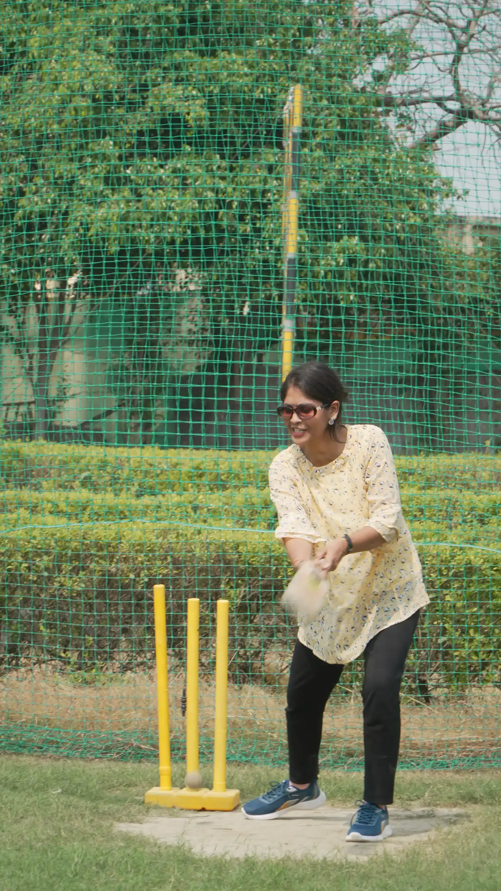 Bowling in the box cricket net at Veda Adventures Park