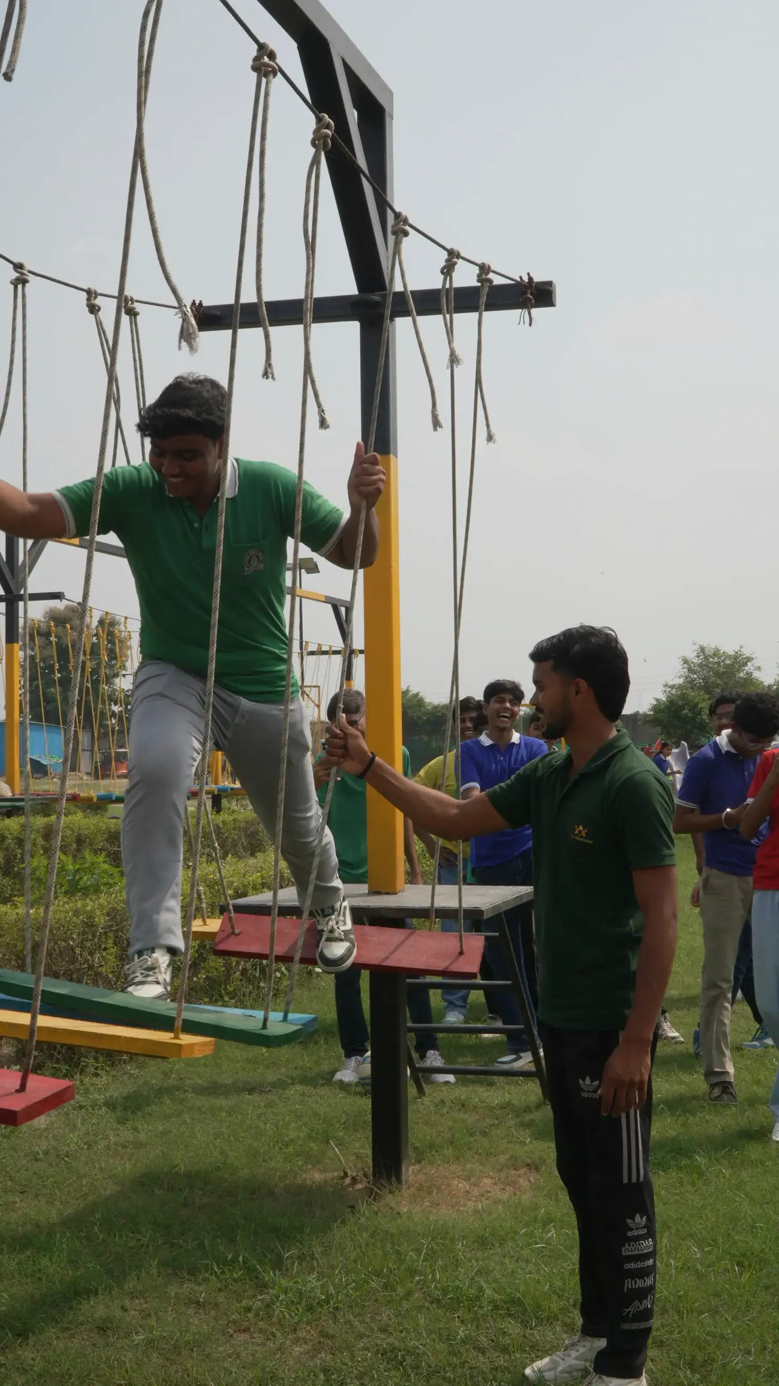 Indian student crossing a supervised rope course at Veda Adventures Park