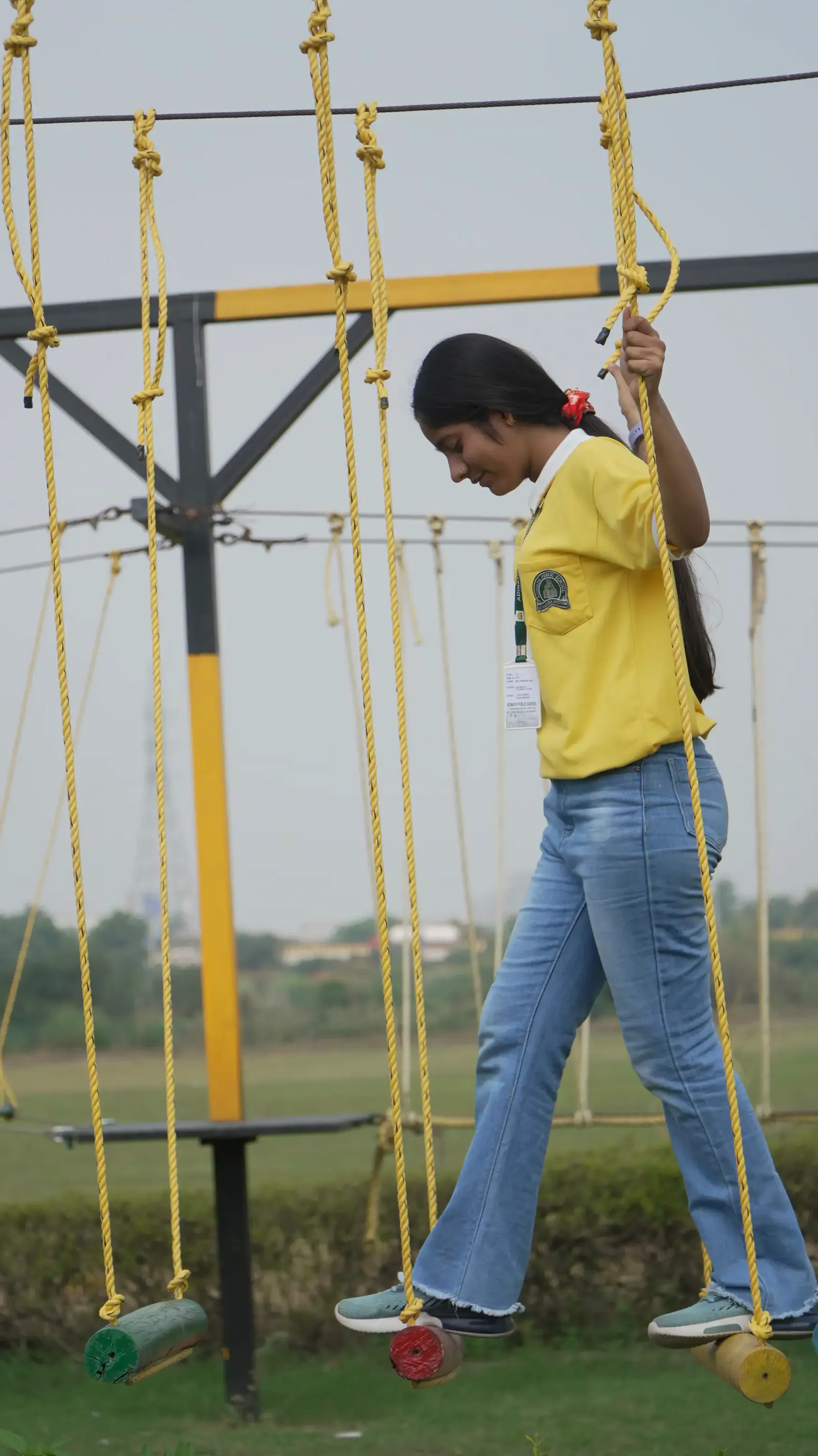 Climbing the rope ladder on the obstacle course at Veda Adventures
