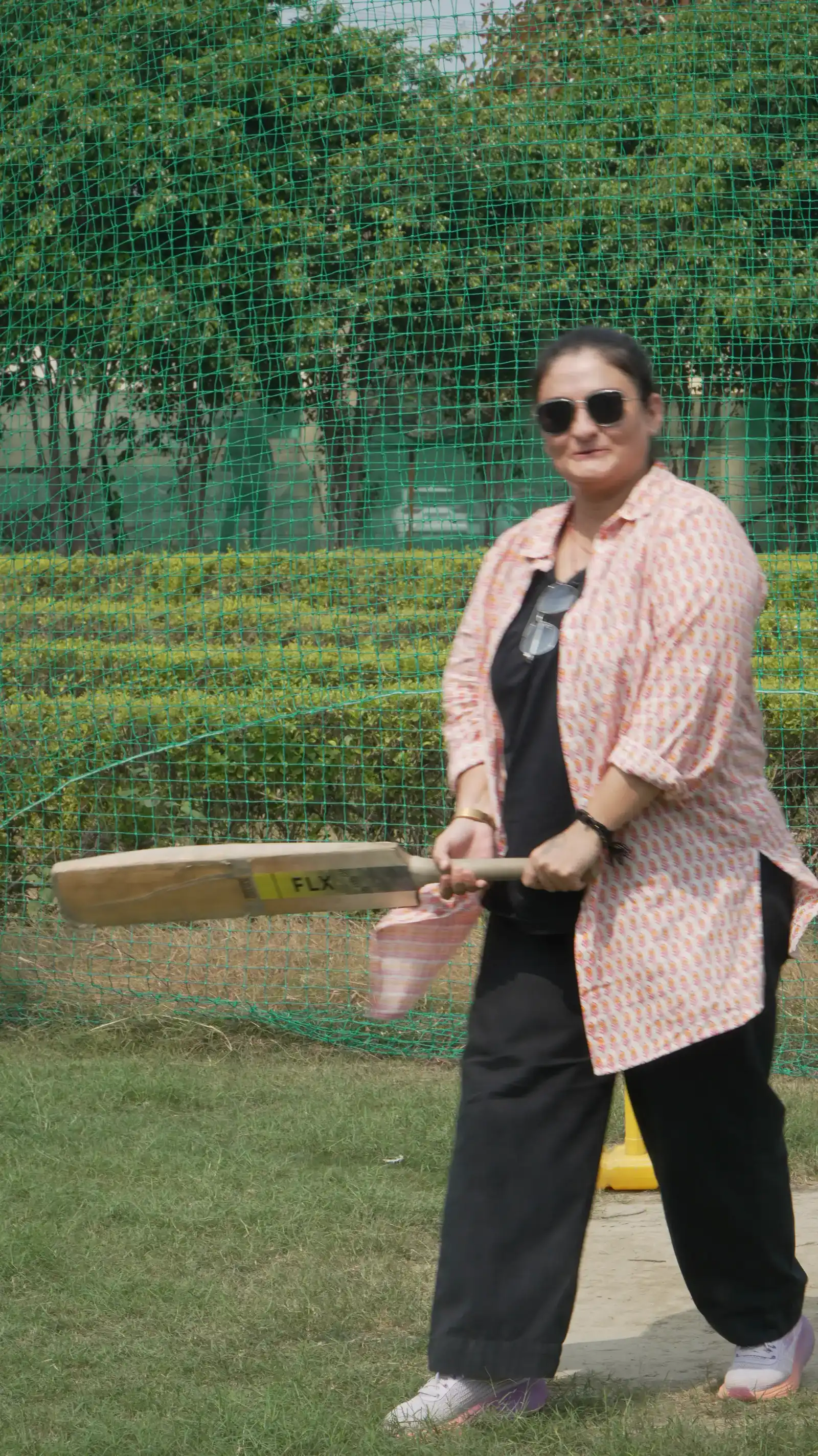 Colleagues playing box cricket at Veda Adventures Park