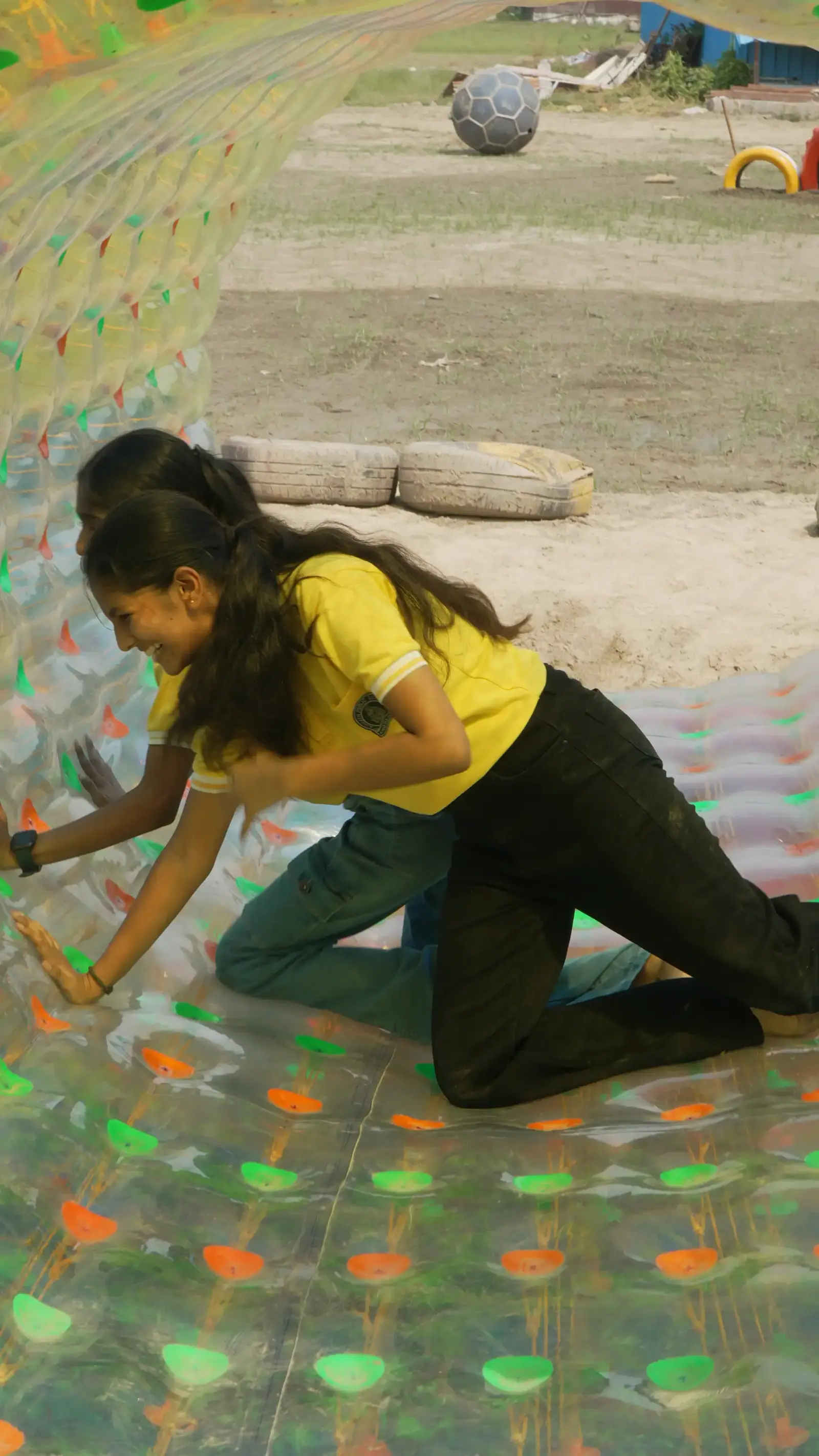 Corporate team taking on the zorb ball during a team outing in Noida