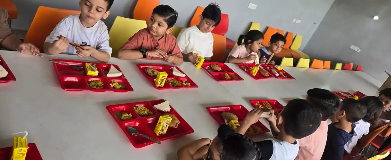 Students eating their picnic meal at the Veda Adventures cafeteria